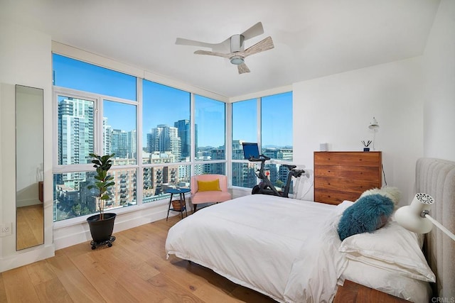 325 7th Unit 1501, San Diego, CA 92101 - bedroom with a city view, wood finished floors, ceiling fan, and baseboards