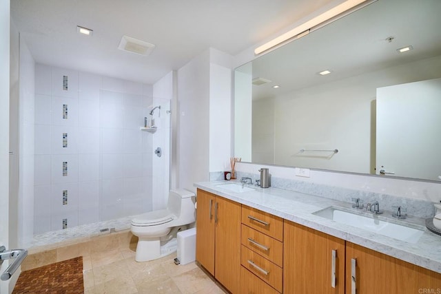 325 7th Unit 1501, San Diego, CA 92101 - bathroom with toilet, double vanity, a tile shower, and tile patterned flooring