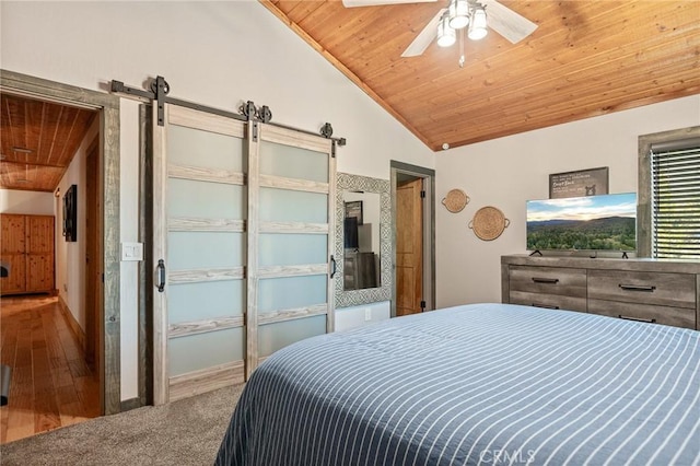 31297 All View Dr, Running Springs, CA 92382 - bedroom featuring wood ceiling, vaulted ceiling, a barn door, ceiling fan, and carpet flooring