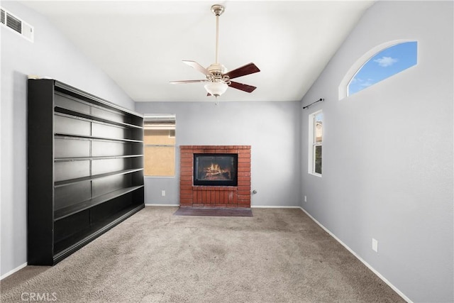 30470 Bayport Ln, Menifee, CA 92584 - unfurnished living room with vaulted ceiling, healthy amount of natural light, carpet flooring, ceiling fan, and a brick fireplace