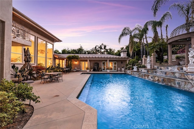 8790 King Ranch Rd, Rancho Cucamonga, CA 91701 - pool at dusk featuring a patio and an outdoor pool