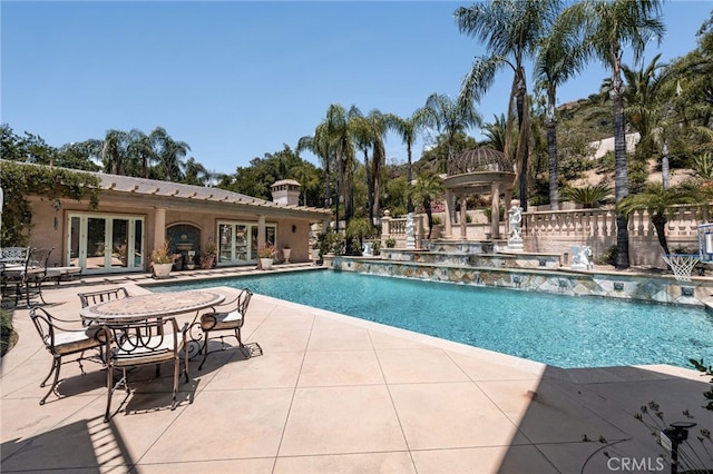8790 King Ranch Rd, Rancho Cucamonga, CA 91701 - swimming pool featuring french doors and a patio