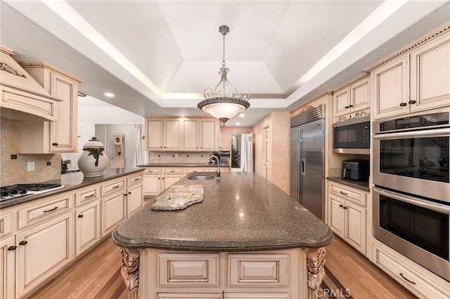 8790 King Ranch Rd, Rancho Cucamonga, CA 91701 - kitchen featuring cream cabinetry, appliances with stainless steel finishes, a raised ceiling, and recessed lighting