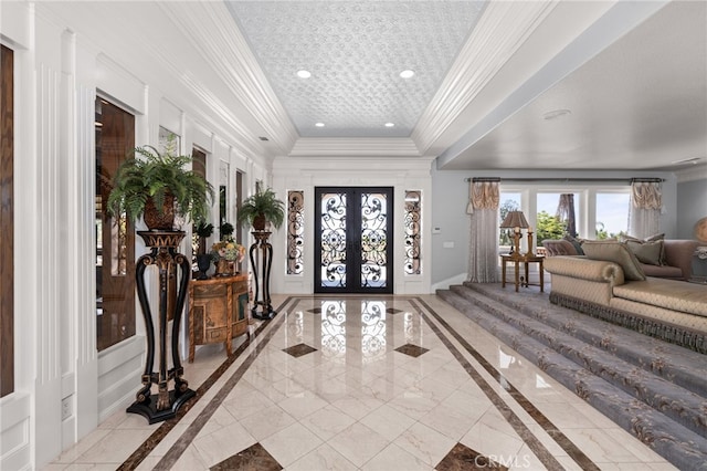 8790 King Ranch Rd, Rancho Cucamonga, CA 91701 - entryway featuring inlaid floor details, a tray ceiling, crown molding, french doors, and recessed lighting