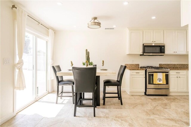 5402 N Fairvalley Ave, Covina, CA 91722 - kitchen with stainless steel appliances, white cabinetry, dark stone counters, and recessed lighting