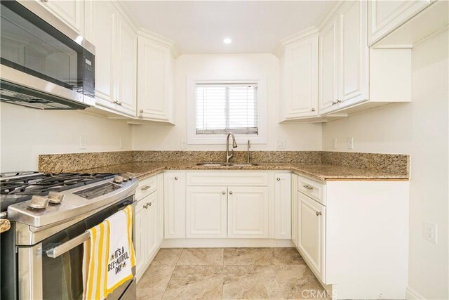 5402 N Fairvalley Ave, Covina, CA 91722 - kitchen with stainless steel appliances, light stone countertops, white cabinetry, and recessed lighting