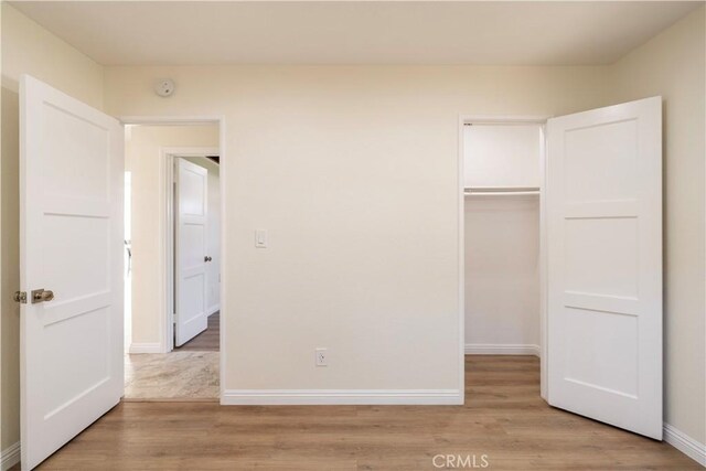 5402 N Fairvalley Ave, Covina, CA 91722 - unfurnished bedroom with a closet and light wood-style floors