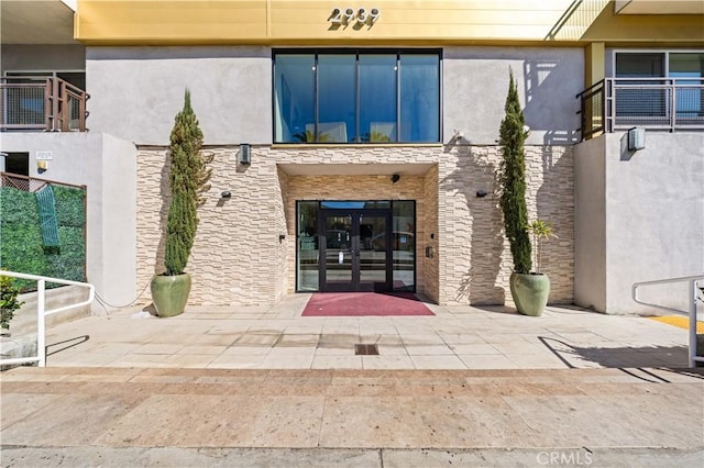2939 Leeward Ave Unit 415, Los Angeles, CA 90005 - doorway to property featuring french doors, stucco siding, and stone siding