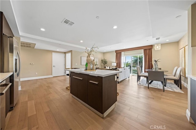 2939 Leeward Ave Unit 415, Los Angeles, CA 90005 - kitchen featuring light countertops, light wood-type flooring, a center island, and recessed lighting