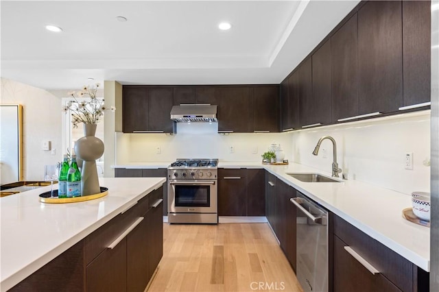 2939 Leeward Ave Unit 415, Los Angeles, CA 90005 - kitchen with stainless steel appliances, a sink, exhaust hood, light wood-type flooring, and light countertops