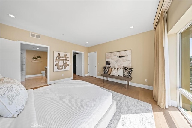 2939 Leeward Ave Unit 415, Los Angeles, CA 90005 - bedroom with light wood finished floors, baseboards, and connected bathroom