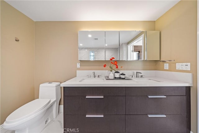 2939 Leeward Ave Unit 415, Los Angeles, CA 90005 - bathroom featuring double vanity, toilet, marble finish floors, and baseboards