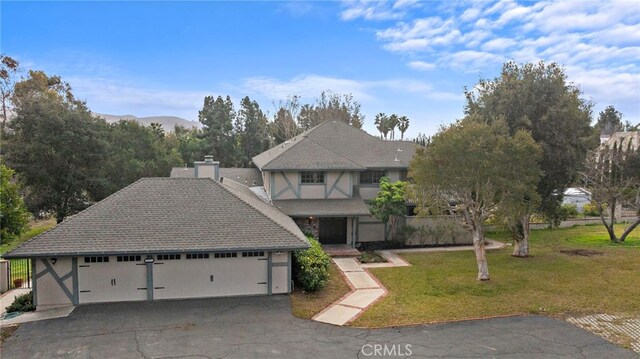 31593 Aguacate Rd, San Juan Capistrano, CA 92675 - english style home with a front lawn, a garage, stucco siding, and a shingled roof