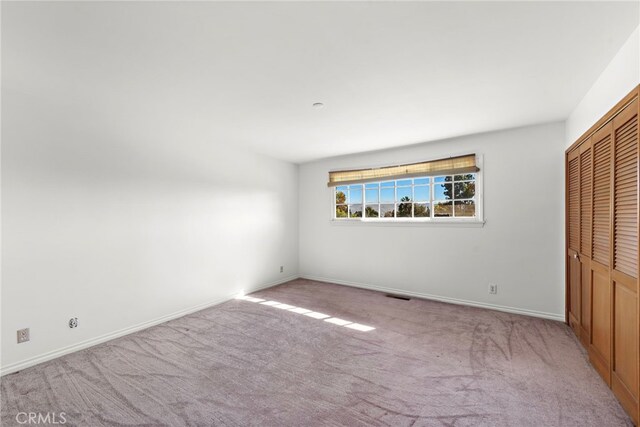 31593 Aguacate Rd, San Juan Capistrano, CA 92675 - unfurnished bedroom featuring light colored carpet, a closet, and baseboards