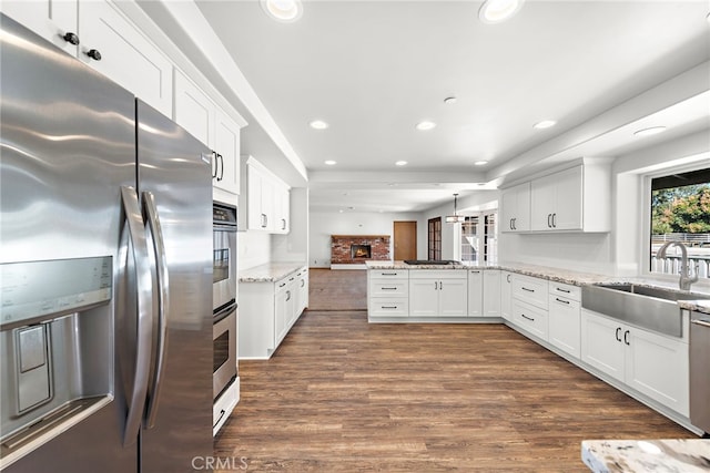 31593 Aguacate Rd, San Juan Capistrano, CA 92675 - kitchen featuring stainless steel fridge with ice dispenser, a sink, a peninsula, recessed lighting, and white cabinetry