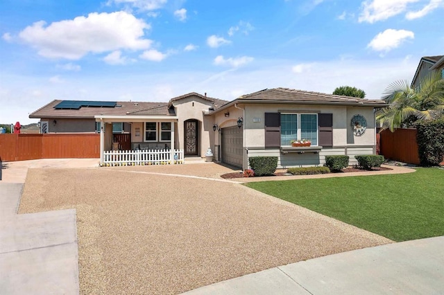 1139 Prussian, Oceanside, CA 92057 - mediterranean / spanish house featuring an attached garage, roof mounted solar panels, stucco siding, and driveway