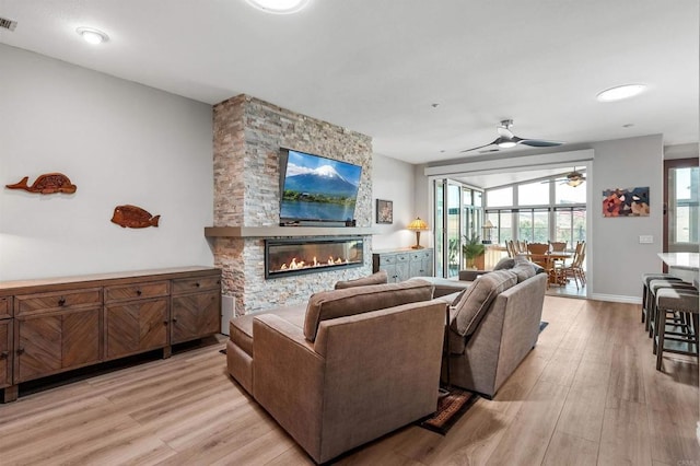 1139 Prussian, Oceanside, CA 92057 - living area with a ceiling fan, light wood-style flooring, a stone fireplace, and plenty of natural light