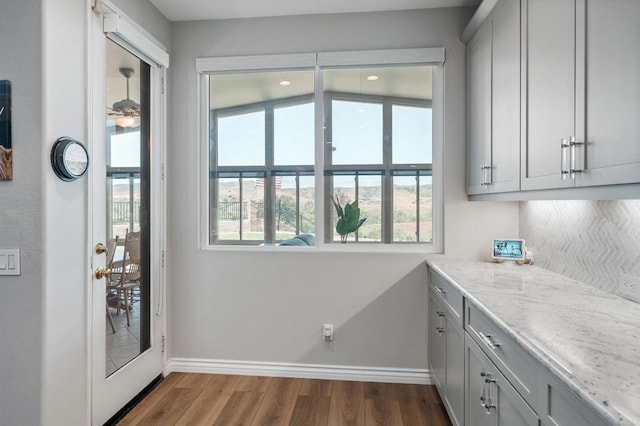 1139 Prussian, Oceanside, CA 92057 - kitchen featuring dark wood finished floors, gray cabinets, and light stone counters
