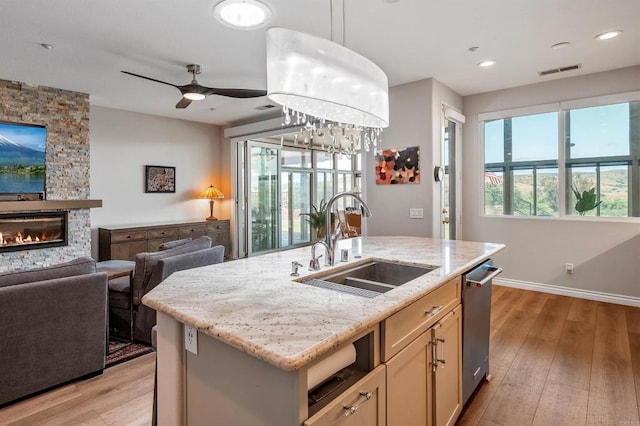 1139 Prussian, Oceanside, CA 92057 - kitchen with light wood-type flooring, light stone counters, open floor plan, a fireplace, and recessed lighting