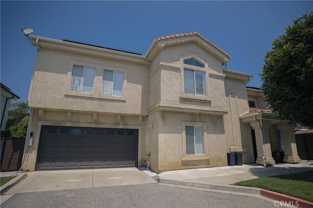 136541/2 Dronfield Ave, Sylmar, CA 91342 - view of front facade featuring an attached garage, stucco siding, and concrete driveway