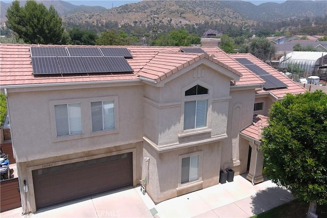 136541/2 Dronfield Ave, Sylmar, CA 91342 - view of front facade with a mountain view, stucco siding, and a garage