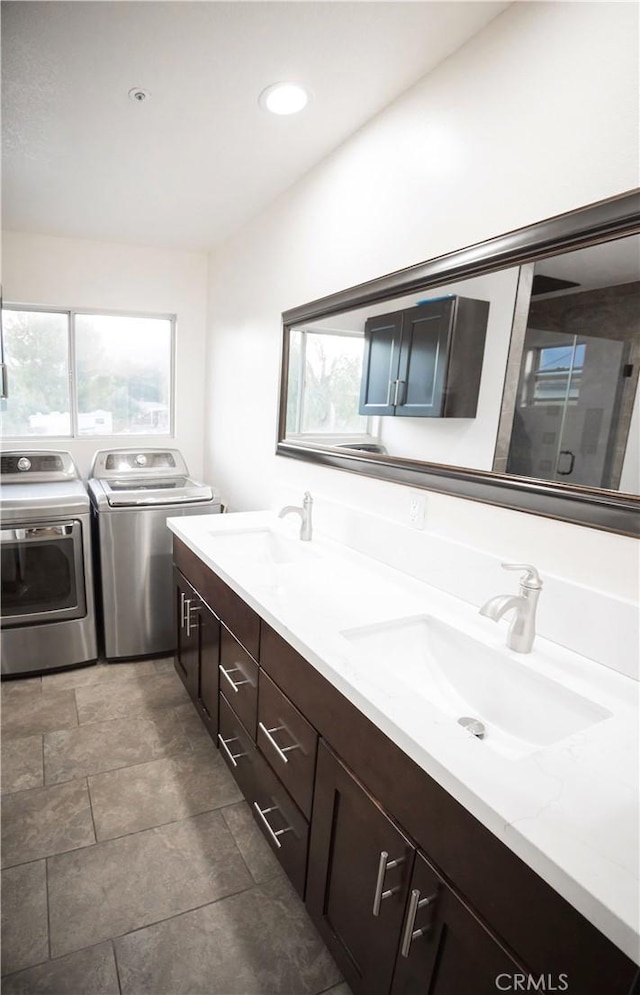 136541/2 Dronfield Ave, Sylmar, CA 91342 - bathroom with separate washer and dryer, healthy amount of natural light, double vanity, stone finish flooring, and recessed lighting