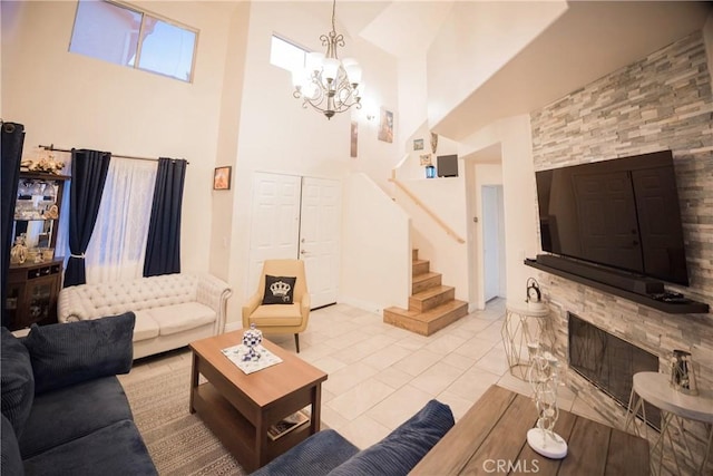 136541/2 Dronfield Ave, Sylmar, CA 91342 - tiled living area featuring a towering ceiling, stairway, a chandelier, baseboards, and a fireplace