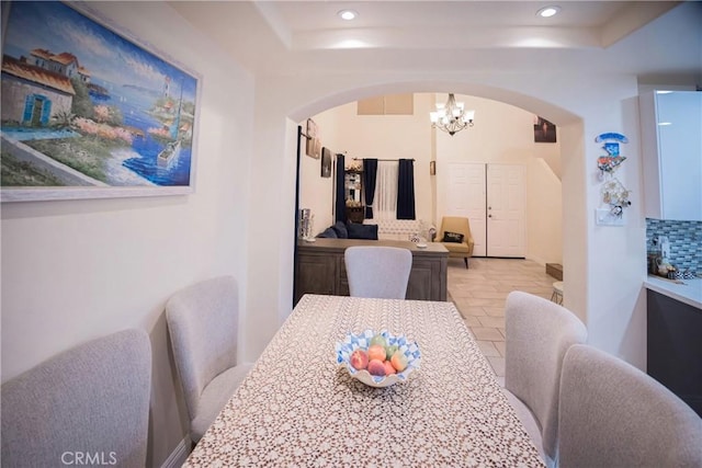 136541/2 Dronfield Ave, Sylmar, CA 91342 - dining space with arched walkways, a chandelier, a raised ceiling, and recessed lighting