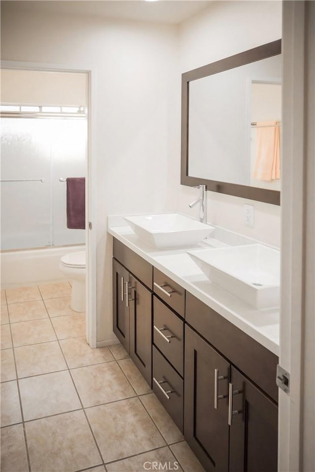 136541/2 Dronfield Ave, Sylmar, CA 91342 - bathroom with double vanity, toilet, combined bath / shower with glass door, and tile patterned flooring