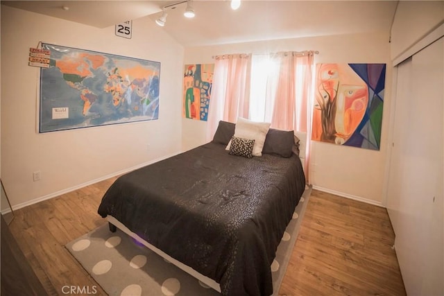 136541/2 Dronfield Ave, Sylmar, CA 91342 - bedroom featuring wood finished floors, track lighting, and baseboards