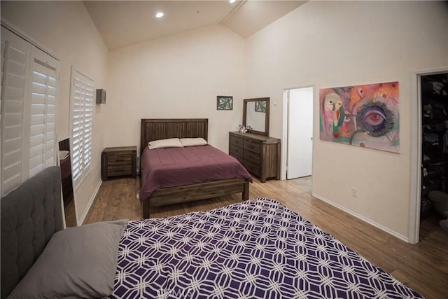 136541/2 Dronfield Ave, Sylmar, CA 91342 - bedroom with baseboards, wood finished floors, high vaulted ceiling, and a spacious closet