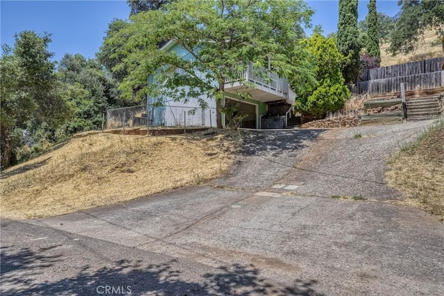 12410 Lakeview Dr, Clearlake Oaks, CA 95423 - view of front facade featuring concrete driveway, an attached garage, and stairway