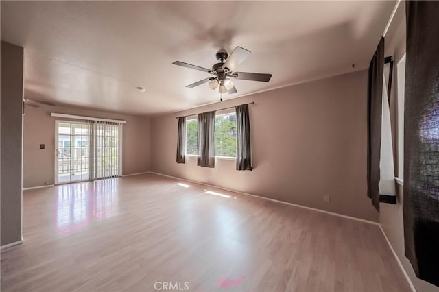 12410 Lakeview Dr, Clearlake Oaks, CA 95423 - spare room featuring wood finished floors, a ceiling fan, and baseboards
