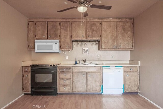 12410 Lakeview Dr, Clearlake Oaks, CA 95423 - kitchen with white appliances, a sink, baseboards, and light countertops