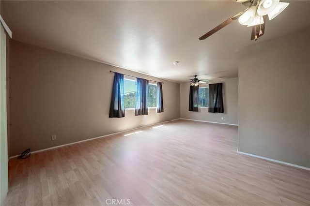 12410 Lakeview Dr, Clearlake Oaks, CA 95423 - spare room featuring ceiling fan, light wood-style floors, and baseboards