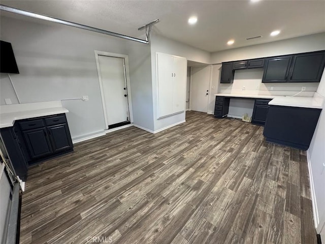 26433 Emerald Dove Dr, Valencia, CA 91355 - kitchen with dark wood-style flooring, recessed lighting, light countertops, baseboards, and dark cabinets