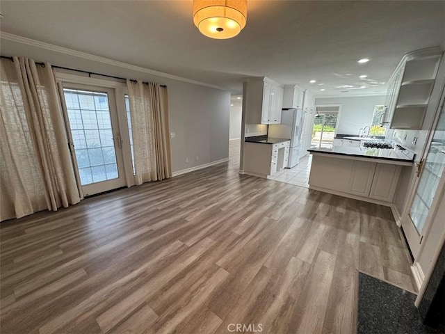 26433 Emerald Dove Dr, Valencia, CA 91355 - unfurnished living room featuring ornamental molding, light wood-style floors, baseboards, recessed lighting, and a sink