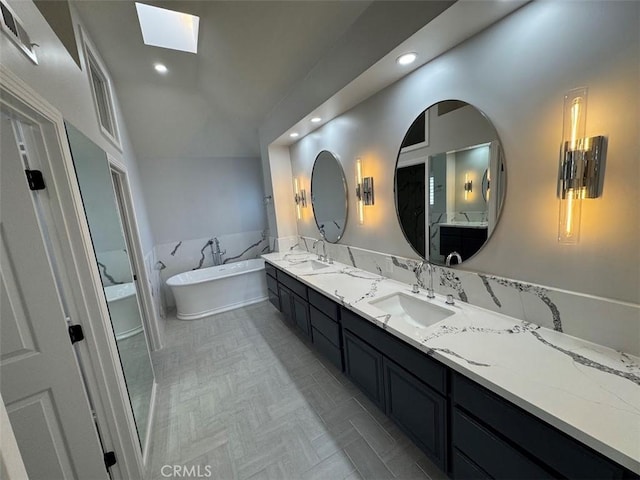 26433 Emerald Dove Dr, Valencia, CA 91355 - full bathroom featuring a skylight, double vanity, a freestanding tub, lofted ceiling, and recessed lighting