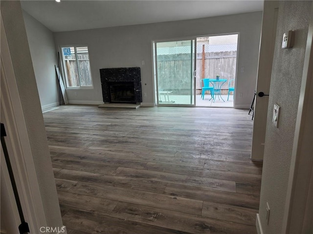 317 Pennyroyal Way, Oceanside, CA 92057 - unfurnished living room with dark wood finished floors, plenty of natural light, baseboards, a fireplace, and a textured wall