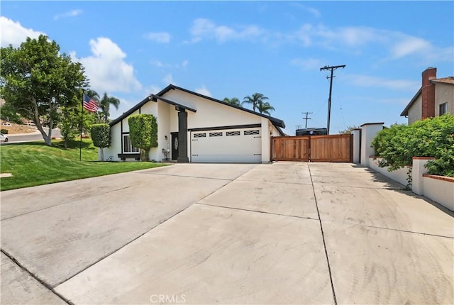 5996 Winncliff Dr, Jurupa Valley, CA 92509 - view of front facade featuring driveway, an attached garage, stucco siding, and a gate