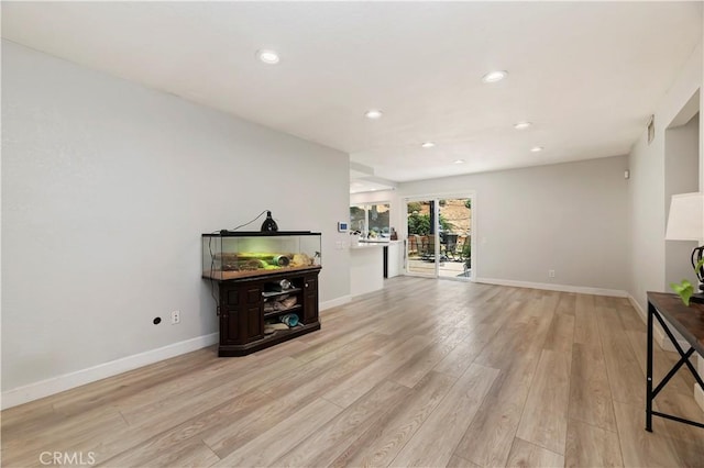 5996 Winncliff Dr, Jurupa Valley, CA 92509 - unfurnished living room with light wood-type flooring, recessed lighting, and baseboards