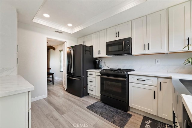 5996 Winncliff Dr, Jurupa Valley, CA 92509 - kitchen featuring black appliances, a tray ceiling, white cabinetry, crown molding, and recessed lighting