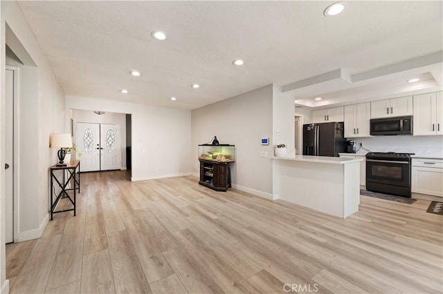 5996 Winncliff Dr, Jurupa Valley, CA 92509 - kitchen featuring black appliances, white cabinetry, recessed lighting, light wood-style floors, and light countertops