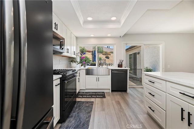 5996 Winncliff Dr, Jurupa Valley, CA 92509 - kitchen featuring appliances with stainless steel finishes, light countertops, ornamental molding, a tray ceiling, and white cabinets