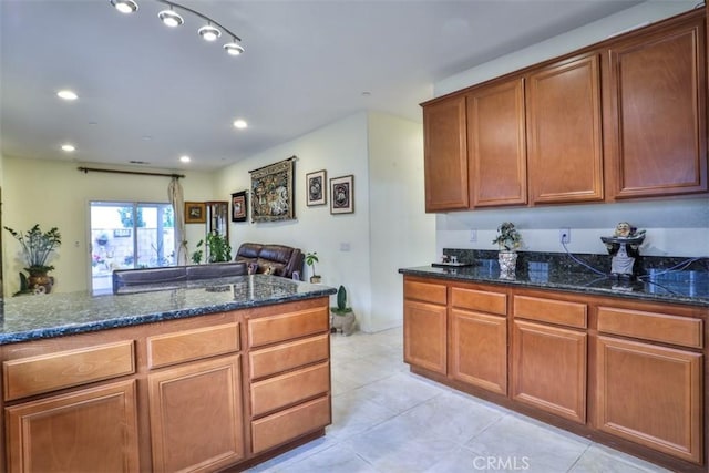 13256 Garcia Ct, Rancho Cucamonga, CA 91739 - kitchen featuring dark stone counters, light tile patterned floors, recessed lighting, and brown cabinetry
