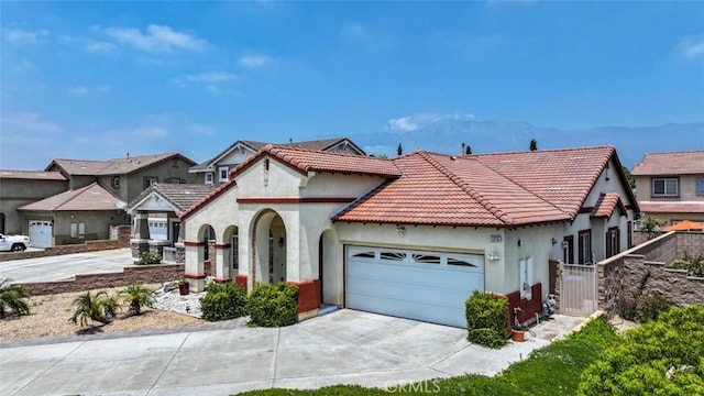 13256 Garcia Ct, Rancho Cucamonga, CA 91739 - view of front of house with stucco siding, a garage, driveway, a tile roof, and a gate