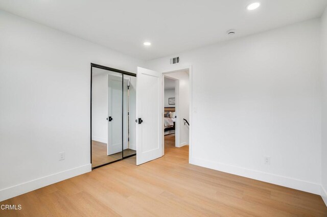 12938 Guadalajara Cir, Cerritos, CA 90703 - unfurnished bedroom featuring baseboards, light wood finished floors, recessed lighting, and a closet