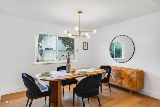 12938 Guadalajara Cir, Cerritos, CA 90703 - dining area with plenty of natural light, a chandelier, light wood-style flooring, and baseboards