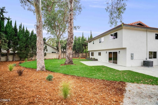12938 Guadalajara Cir, Cerritos, CA 90703 - back of house featuring central AC unit, stucco siding, a patio area, and a tile roof