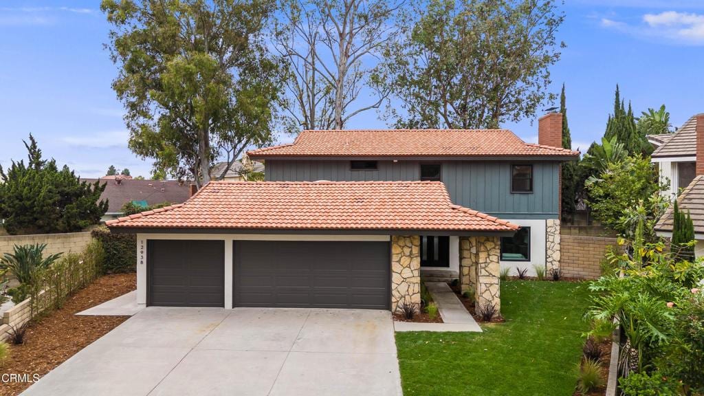 12938 Guadalajara Cir, Cerritos, CA 90703 - view of front of home featuring a chimney, an attached garage, a tile roof, and concrete driveway